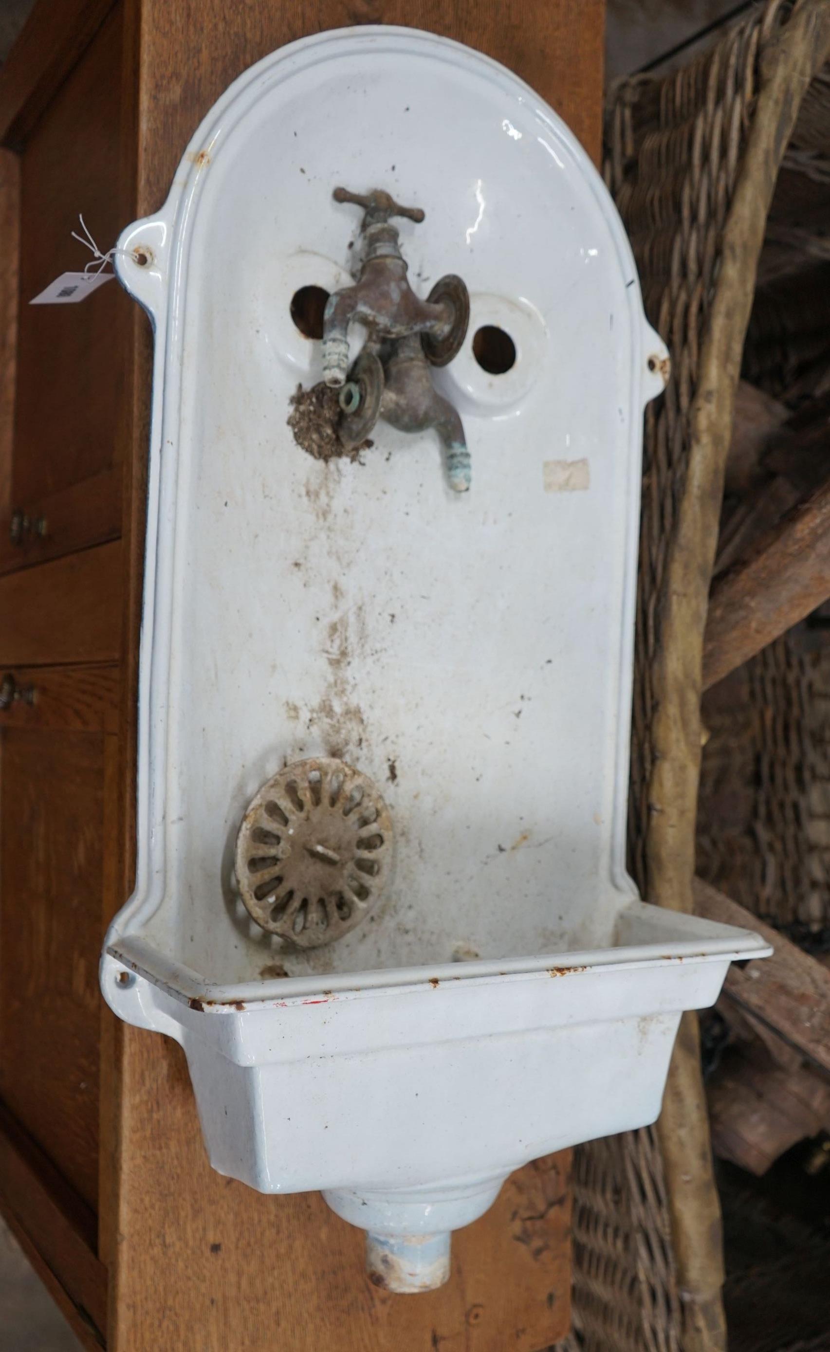 An early 20th century French white enamelled water fountain, height 84cm